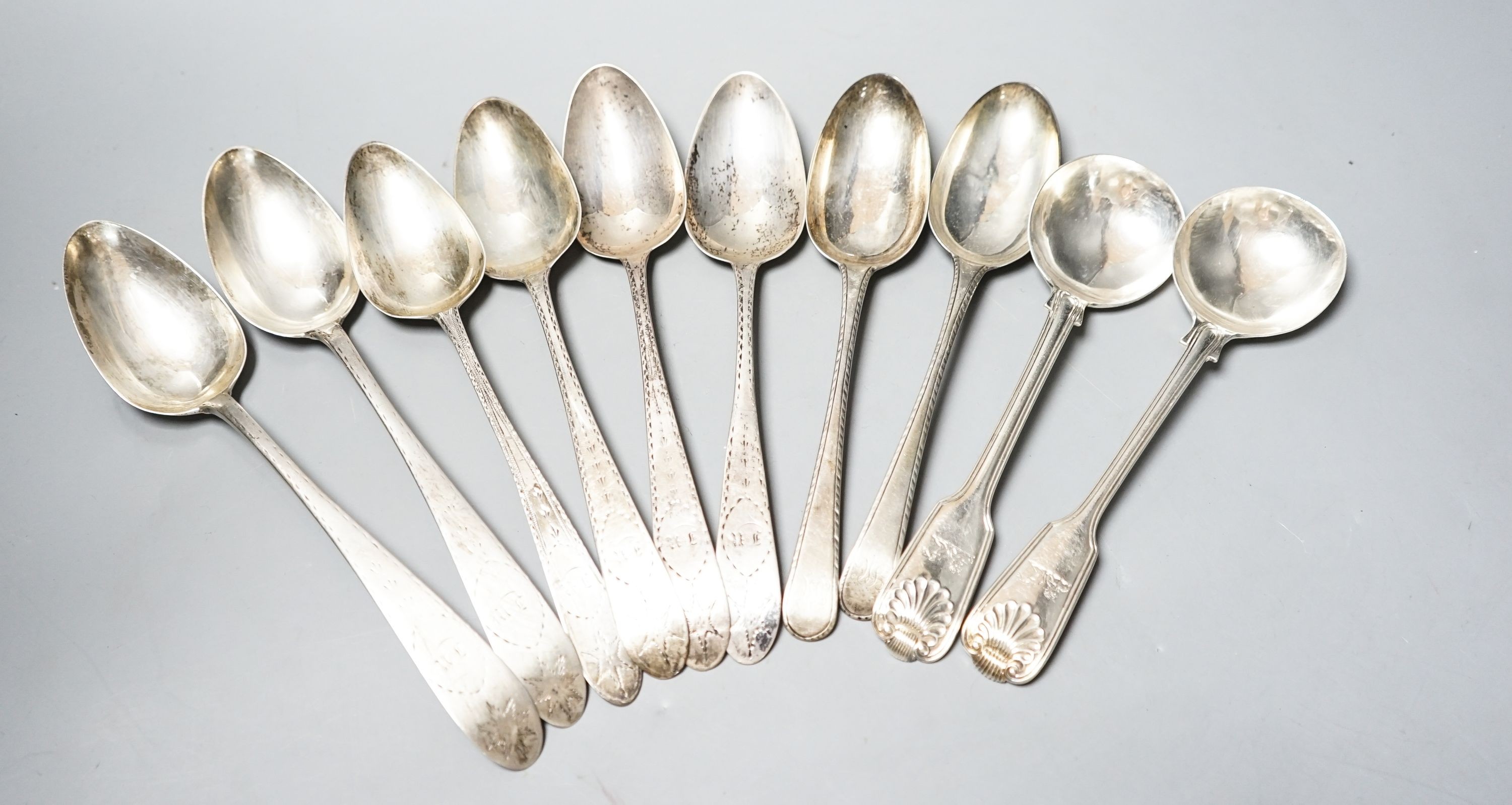 Eight assorted mainly 18th century silver table spoons including Irish, various date and makers(a.f.) and a pair of Victorian fiddles, thread and shell pattern spoons, 20oz.